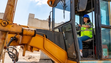 Female construction worker operating an excavator machine