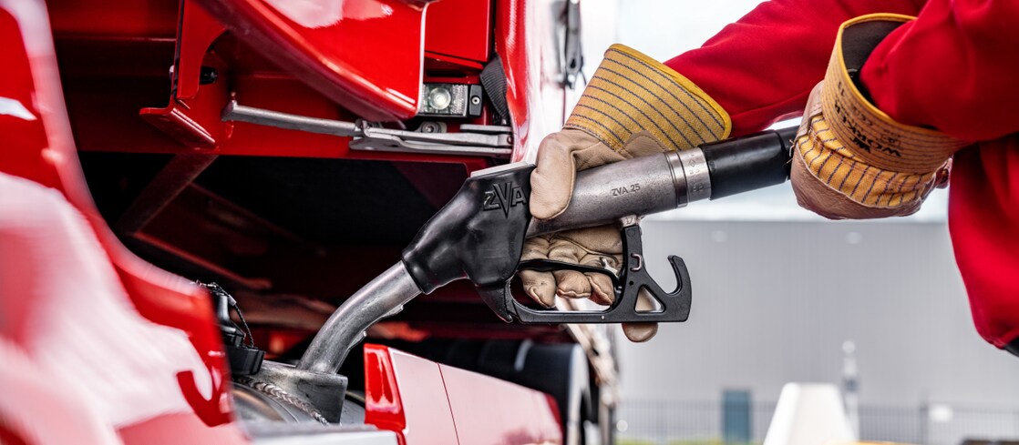 Person using a diesel pump to fill up a lorry