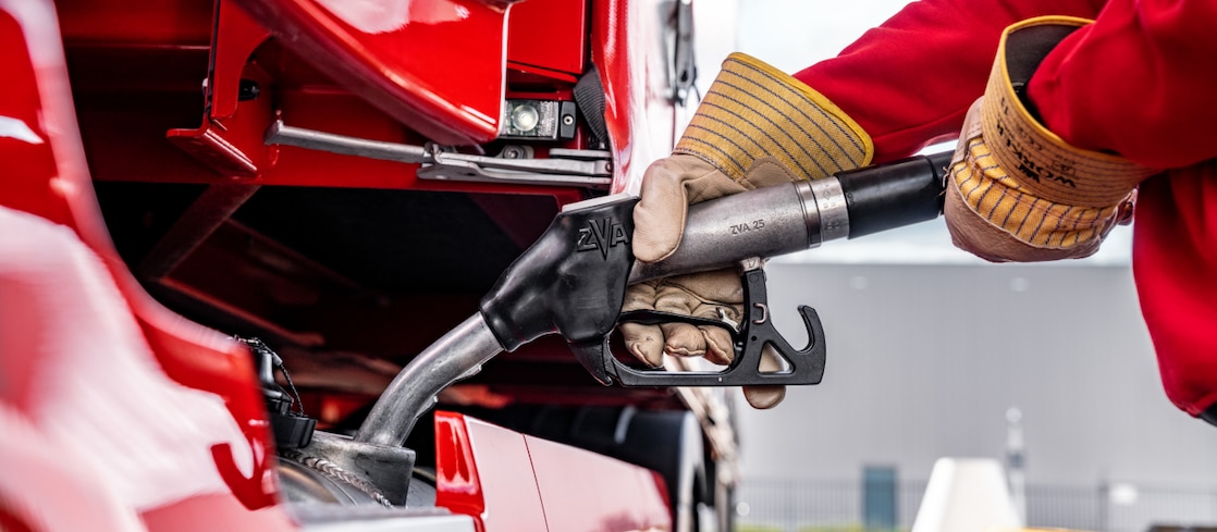 Person using a diesel pump to fill up a lorry