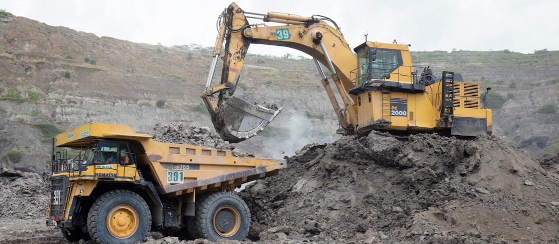 An excavator and a truck on a site