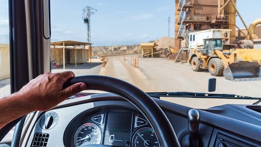 A mans hand on a steering wheel