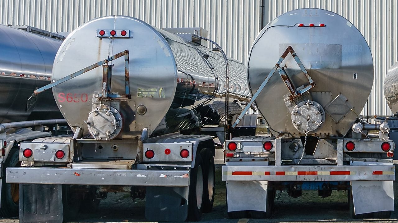 Row of shiny metal tanker trucks