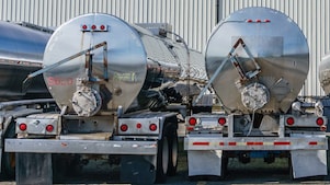 Row of shiny metal tanker trucks
