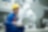 A woman with Protective equipment on a laptop