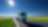 Truck driving on a road past a field