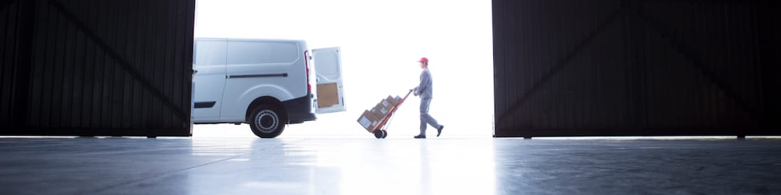 Worker taking boxes to a delivery van