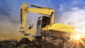 A wheeled digger on top of rocks