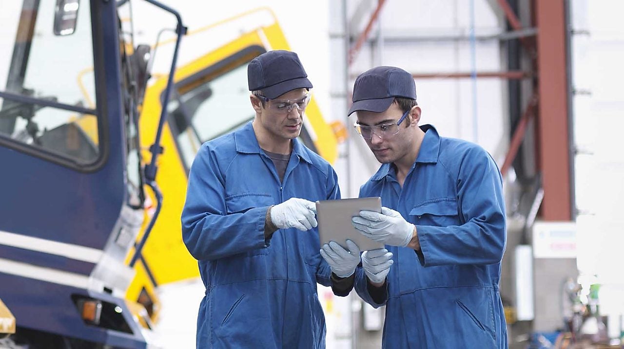 Workers looking at a clipboard