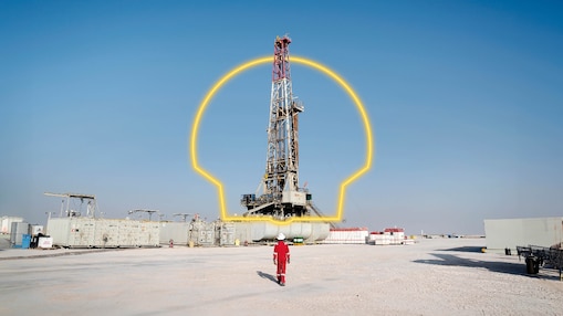 A worker walking towards an oil drilling platform