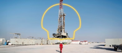 A worker walking towards an oil drilling platform