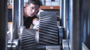 Industry worker greasing equipment