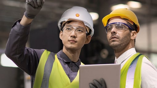 Shell worker consulting an industry worker on site
