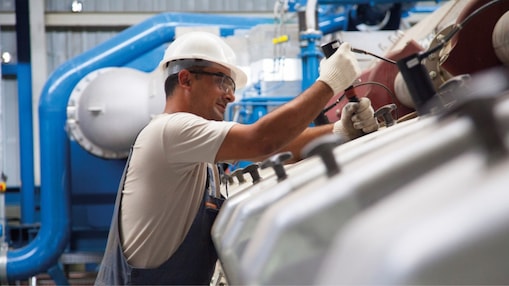 Worker servicing industrial equipment