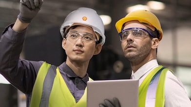 Shell worker consulting an industry worker on site