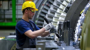 Worker servicing industrial equipment