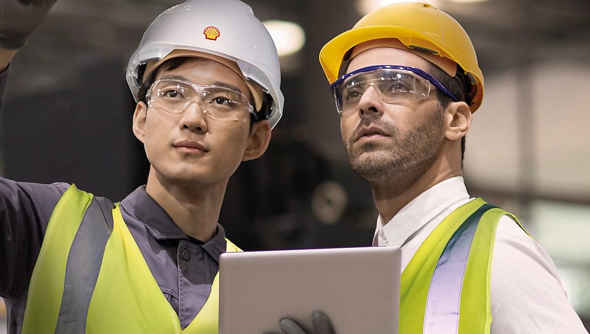 Shell worker consulting an industry worker on site