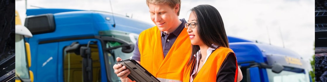 A man and a woman looking at tablet.