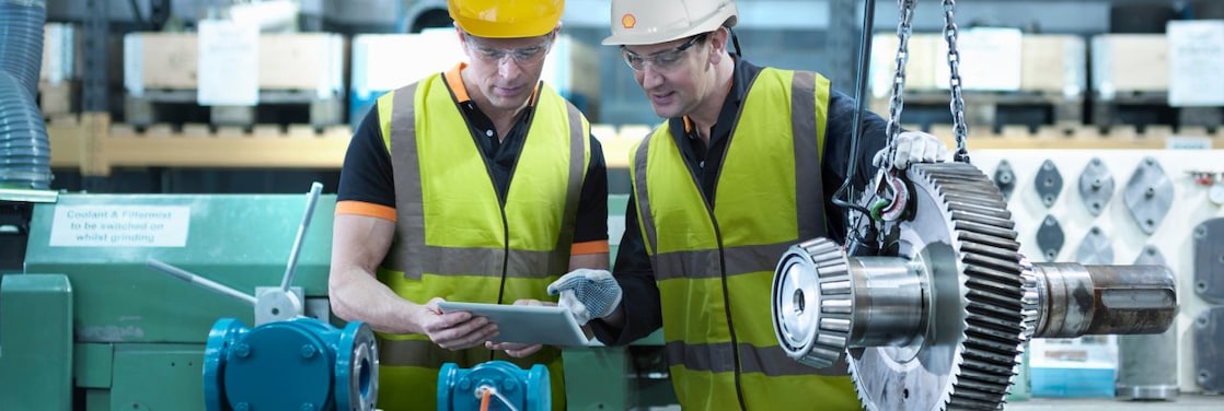 Shell worker consulting an industry worker on site