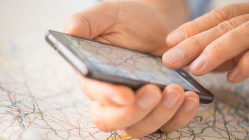 Mans hand navigating on map inside smart phone app