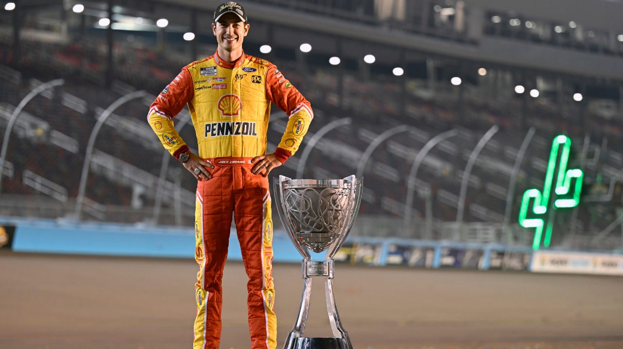logano celebrates victory with trophy