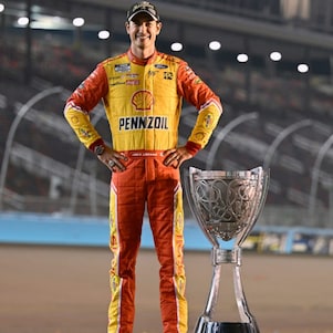 logano celebrates victory with trophy