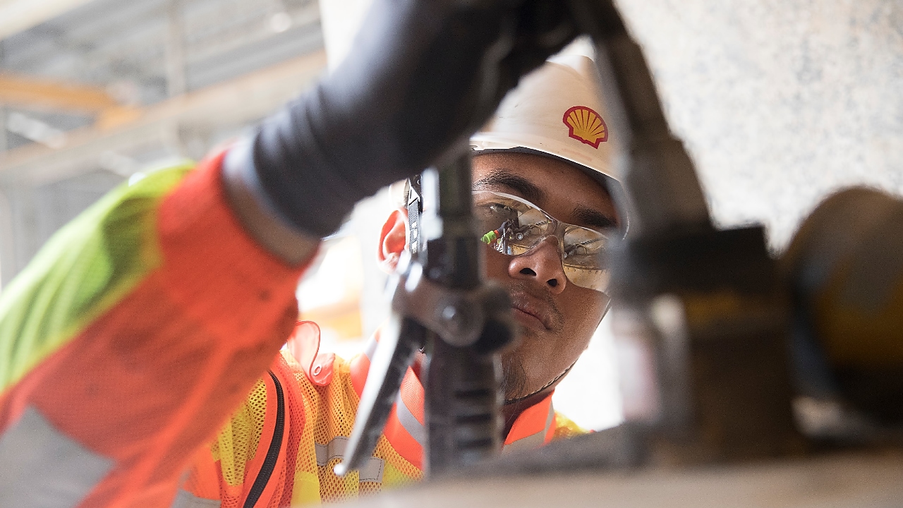 Shell engineer inspecting mining equipment