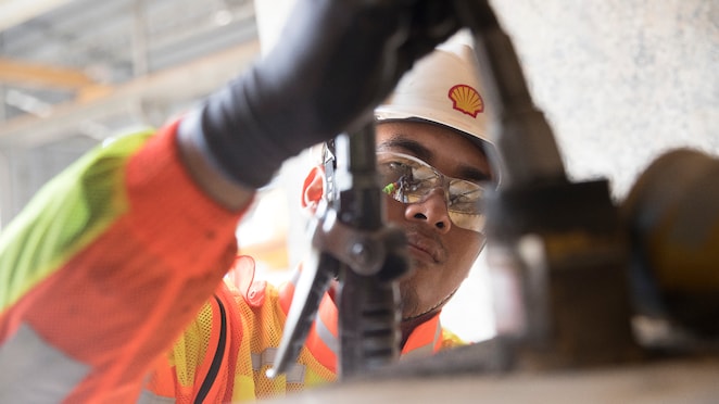 Shell engineer inspecting mining equipment