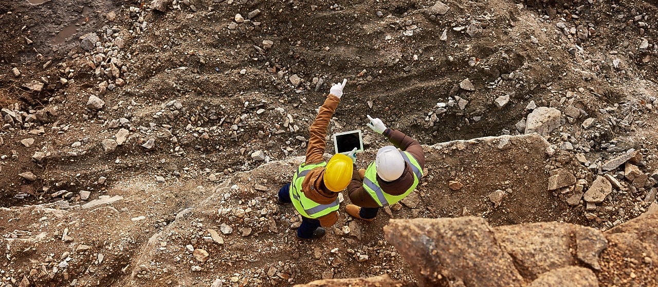 Engineers on tablet studying mine