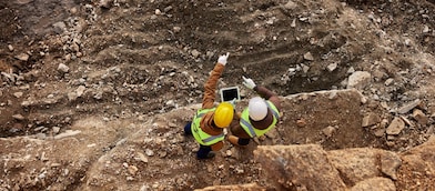 Engineers on tablet studying mine
