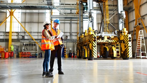 Two employees inspecting a tablet