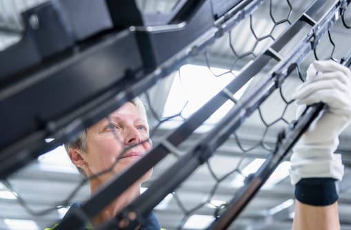 Female working checking automotive part