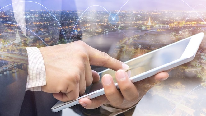 Background of city and image of man and ipad on front