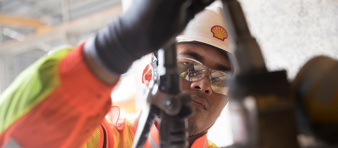 Shell engineer inspecting mining equipment
