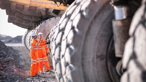 Two engineers standing with mining equipment