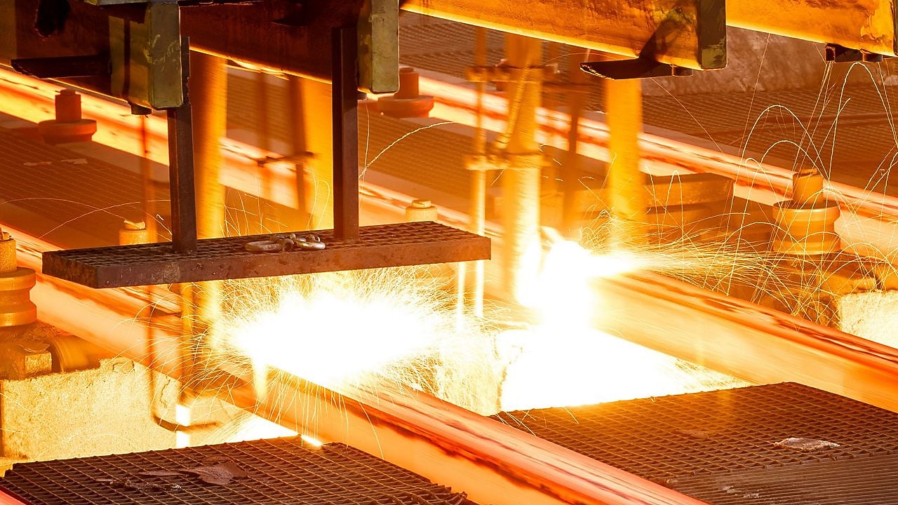 Workers in hard hats in a metal factory