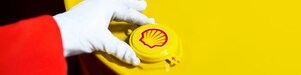 A Shell expert adjusts the lid of a barrel of lubricant displaying the Shell logo