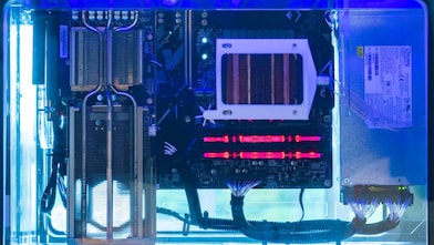 Electronic components submerged in Shell Immersion Cooling Fluid inside a transparent cooling tank.