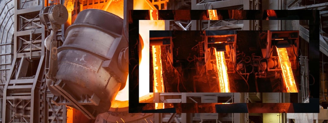 Workers in hard hats in a metal factory