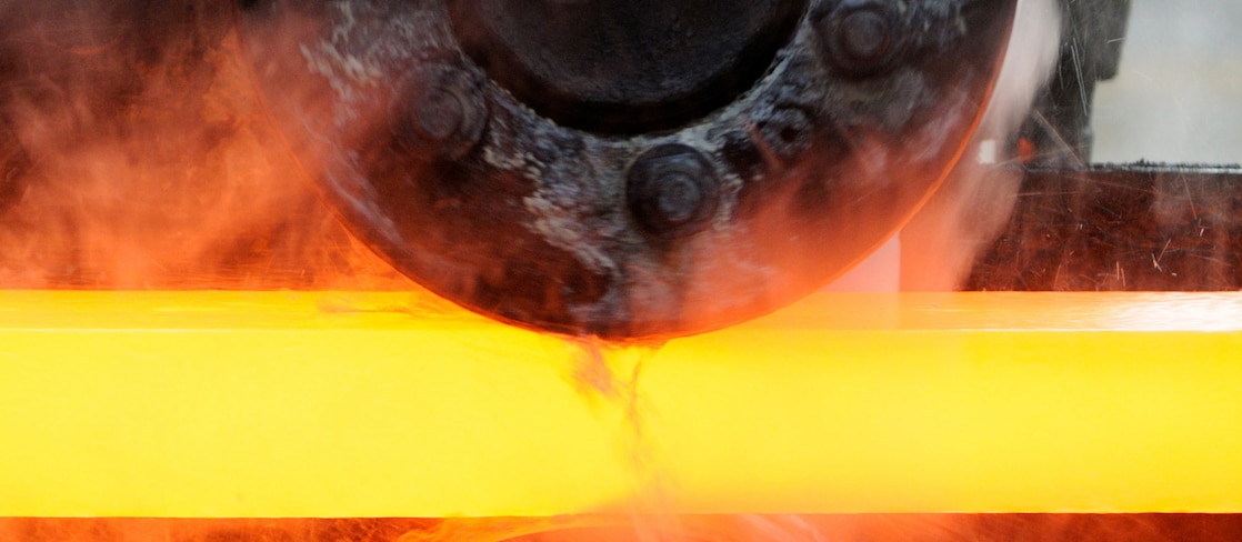 Steel worker mixing melted steel
