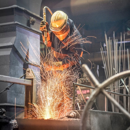 Worker in protective clothing at work in a steel foundry