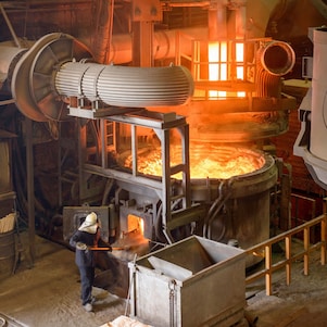 Melted metal inspected by a worker