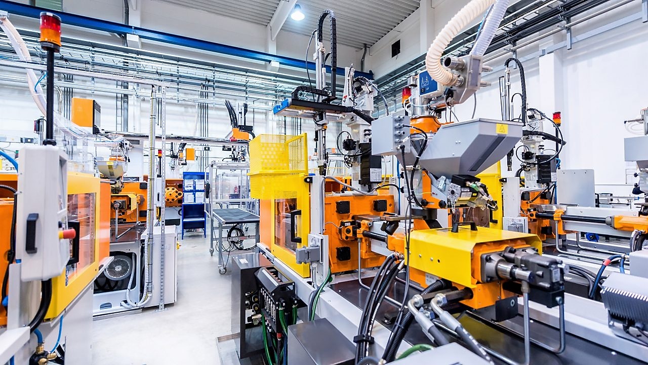 Modern industrial manufacturing facility featuring automated machinery and robotic equipment.