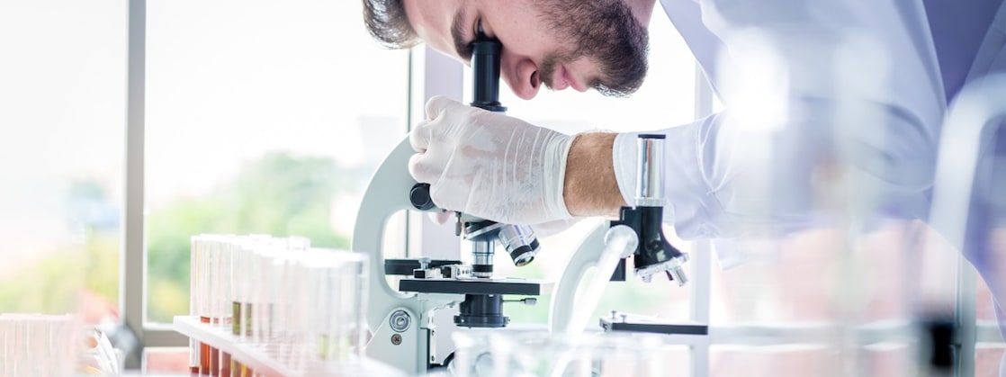 Scientist using a microscope