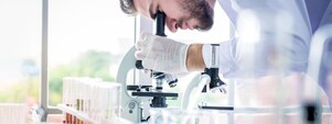 Scientist using a microscope