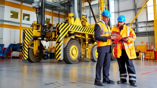 Two employees examining clipboards
