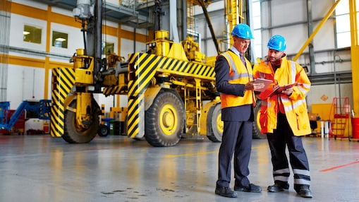 Two employees looking at clipboard
