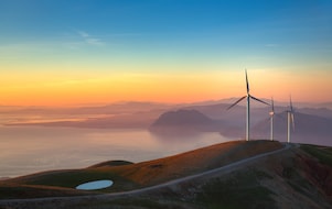 wind turbines overlook a stunning horizon