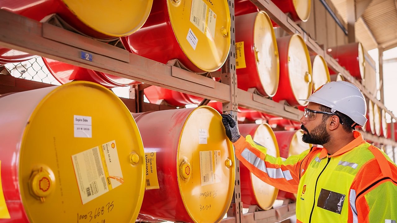 Shell worker inspecting lubricant pails