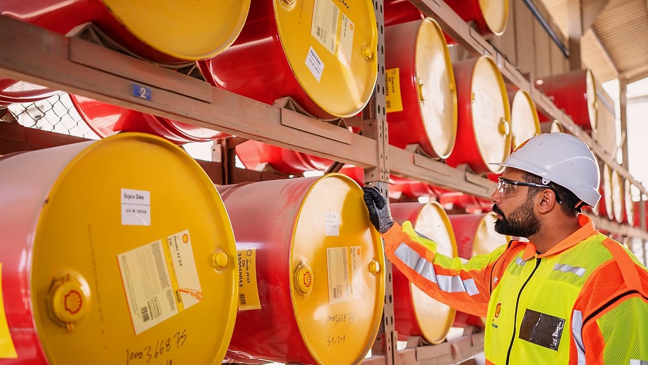 Shell worker inspecting lubricants pails