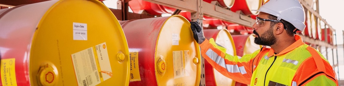 Shell worker inspecting lubricants pails